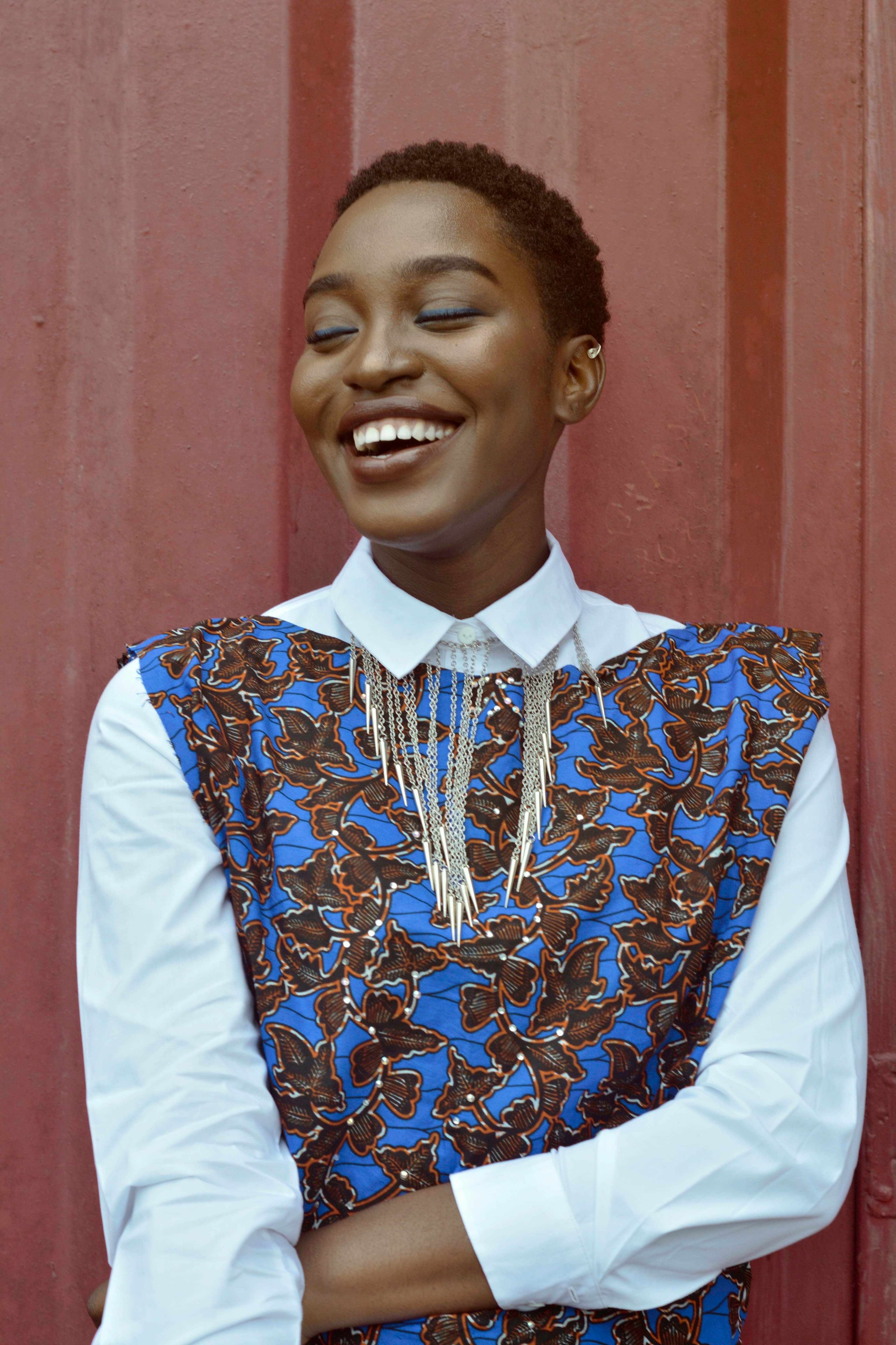 Woman smiling in front of a red wall